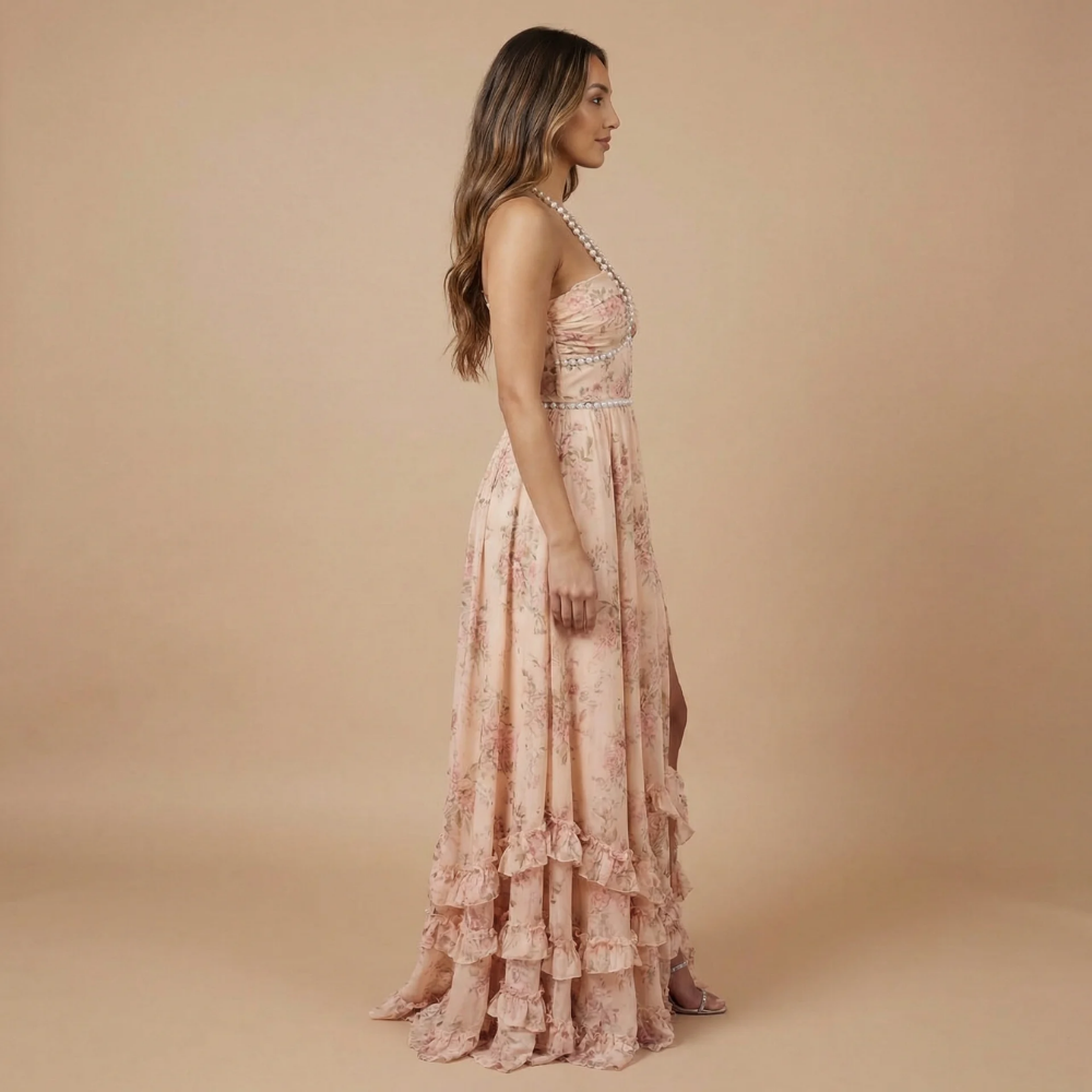 Side view of blush pink floral halter dress with tiered ruffled skirt