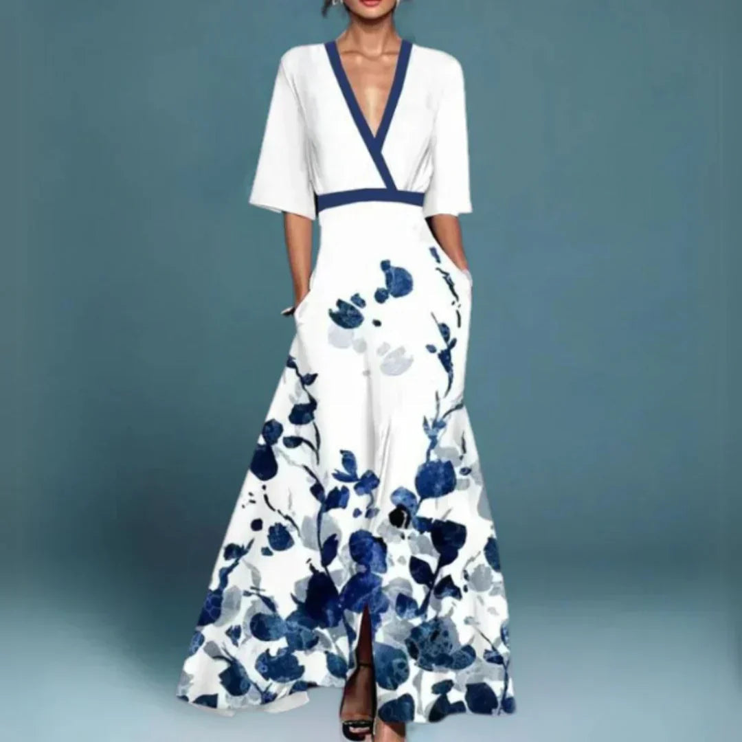 White maxi dress with navy blue floral print, v-neck, half sleeves, and side pockets