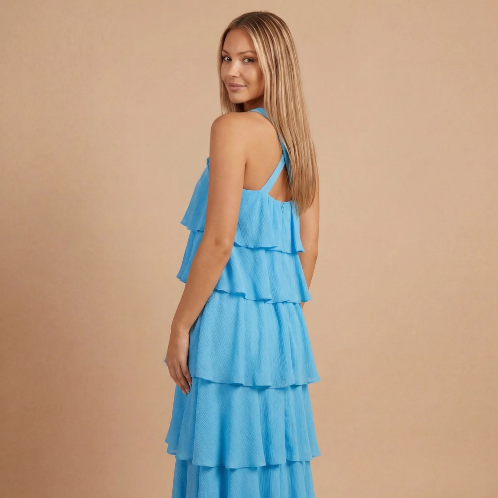 Back view of sky blue halter maxi dress showing textured fabric and layered tiered skirt