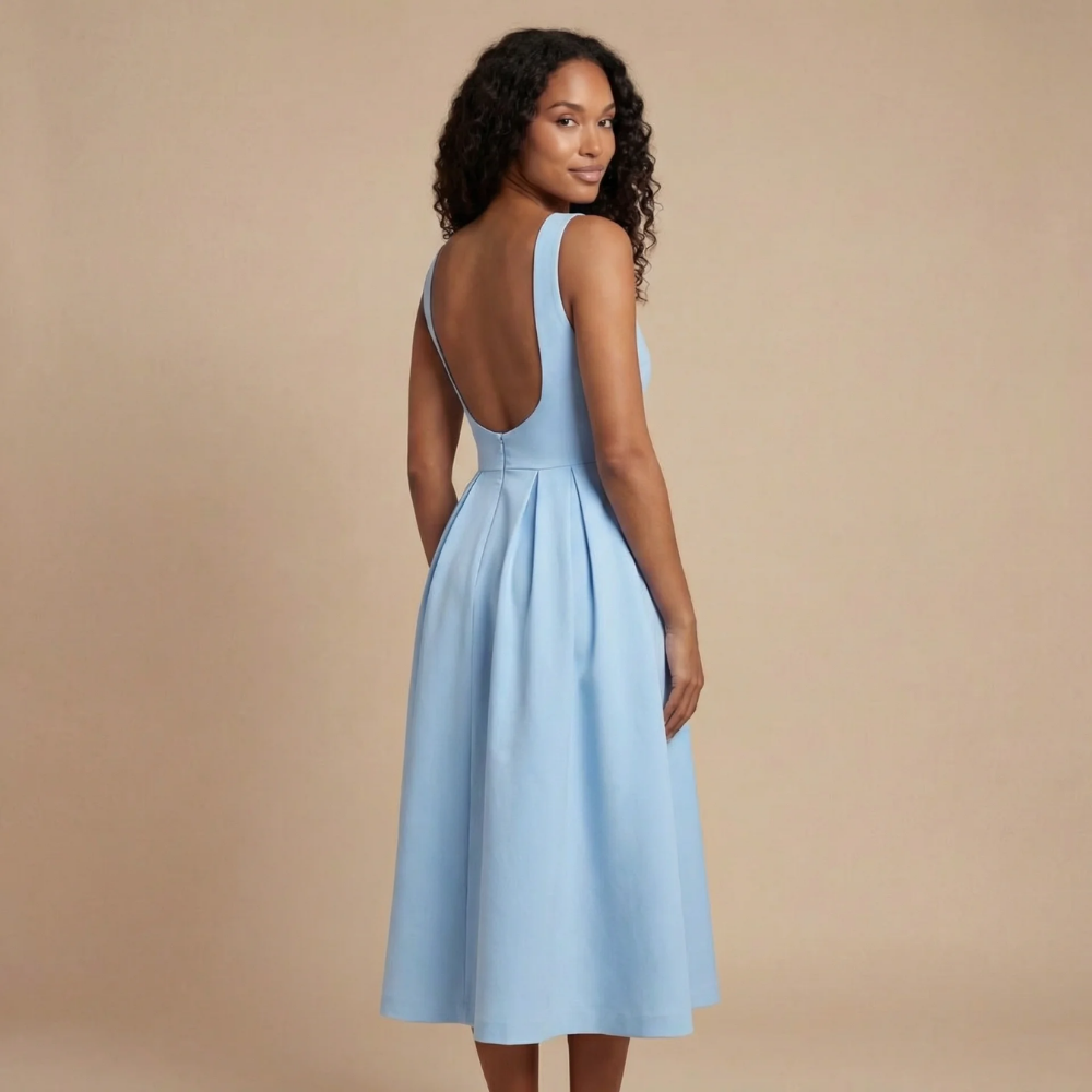 Back view of light blue midi dress with low scoop back and pleated skirt
