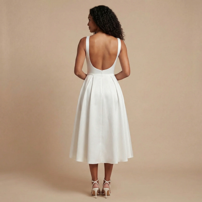 Back view of cream midi dress with open scoop back and full pleated skirt