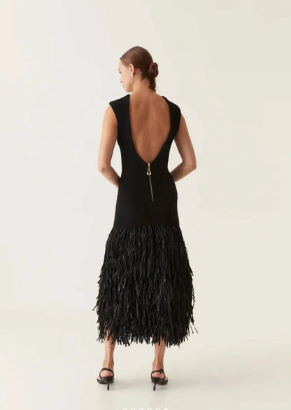 Women's black midi dress back view with deep V-neckline and gold metal zipper closure