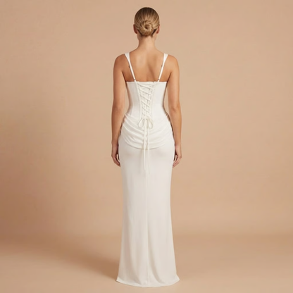 Back view of white ruched dress with lace-up corset closure
