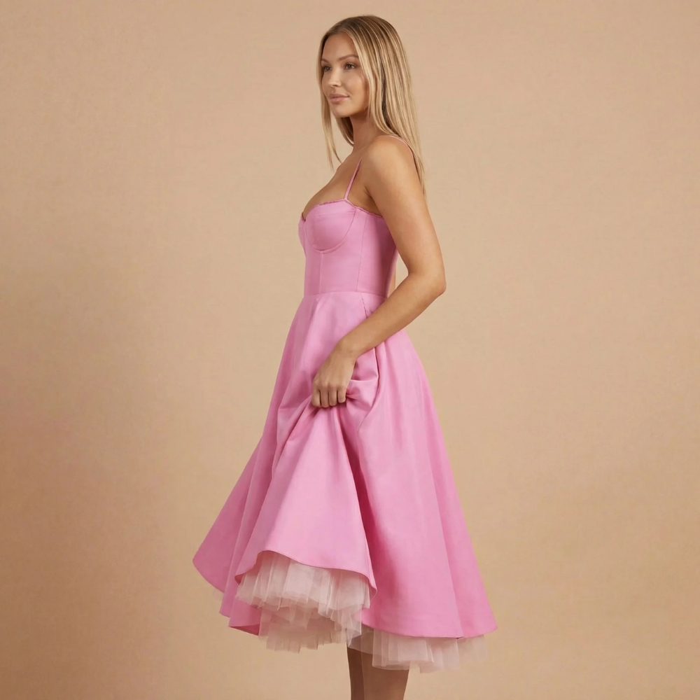 Side view of pink sweetheart midi dress with layered tulle skirt