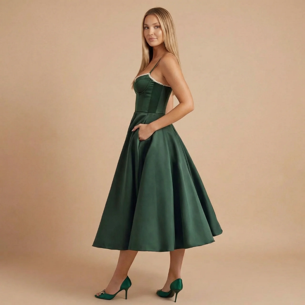 Side view of dark green A-line midi dress with spaghetti straps
