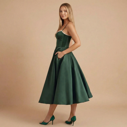 Side view of dark green A-line midi dress with spaghetti straps