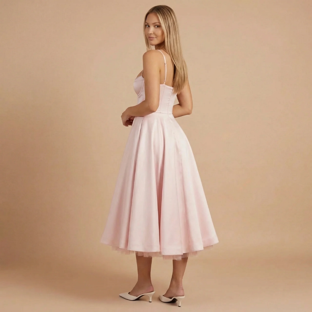 Back view of light pink A-line midi dress with spaghetti straps