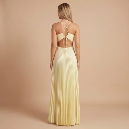 Back view of cream pleated maxi dress showing crossed halter straps and open back
