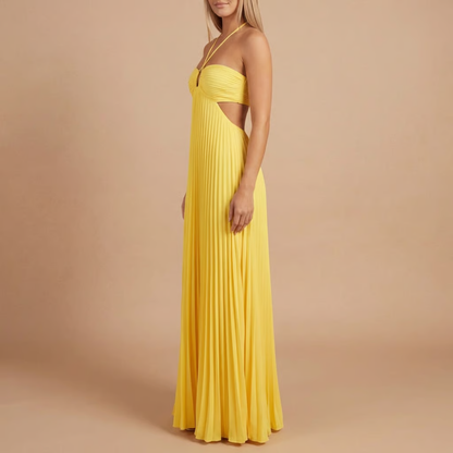 Side profile of yellow pleated maxi dress with side cut-out detail