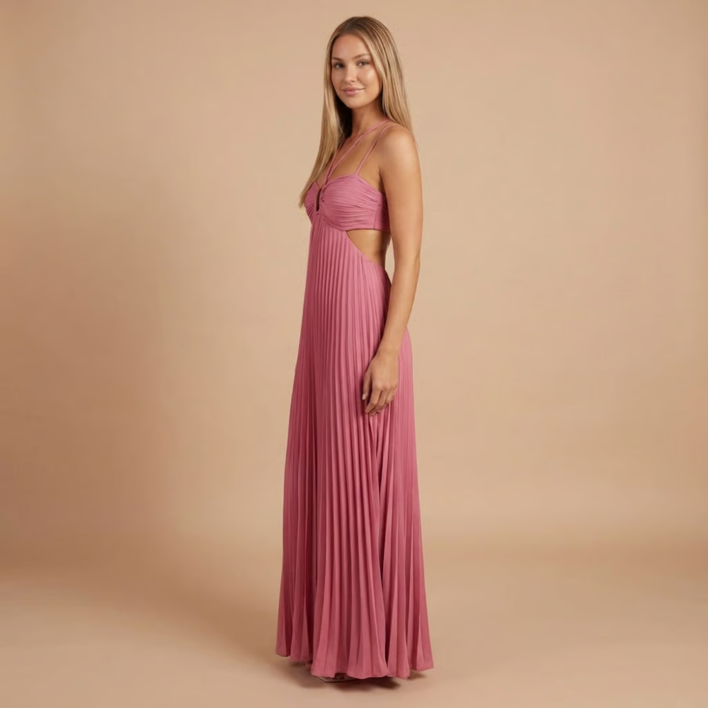 Side view of pink pleated maxi dress showing halter straps and waist opening