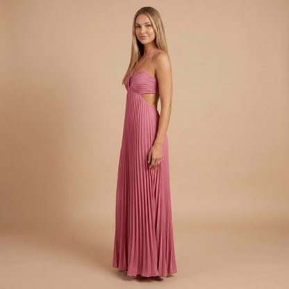 Side view of pink pleated maxi dress showing halter straps and waist opening