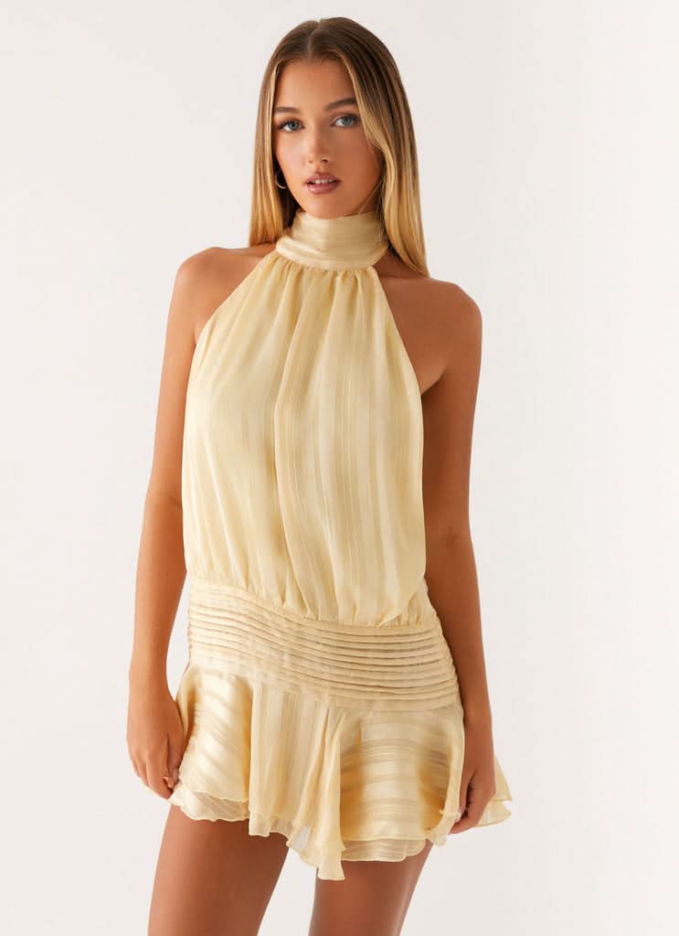 Cream pleated chiffon halter neck mini dress with open back and ruched waist detail