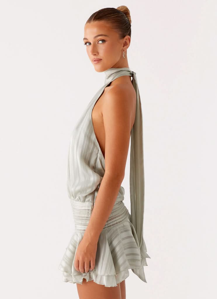 Sage green halter dress back view showing open back design