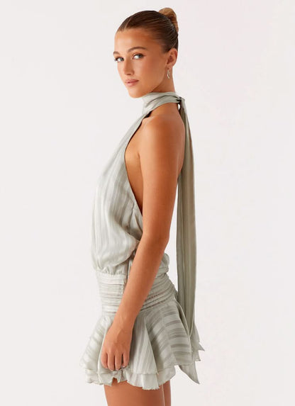 Sage green halter dress back view showing open back design
