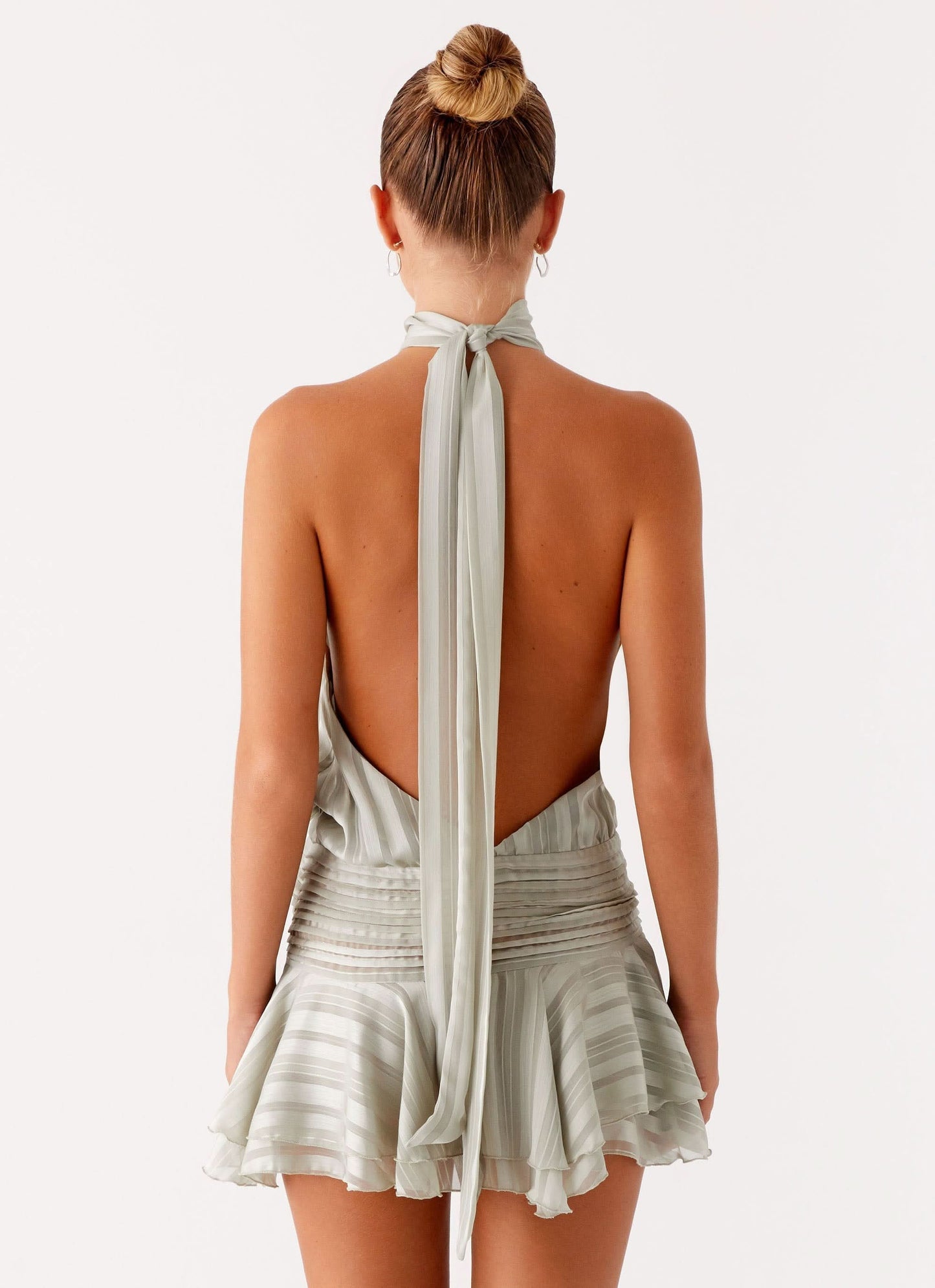 Sage green pleated chiffon halter mini dress with ruffled hem