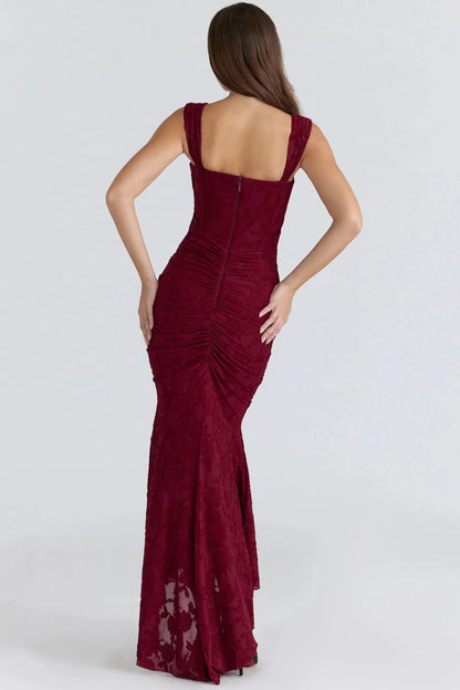 Back view of burgundy corset dress showing open back and high-low hem