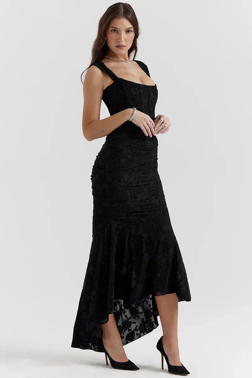 Side profile of black corset dress with asymmetrical high-low hemline