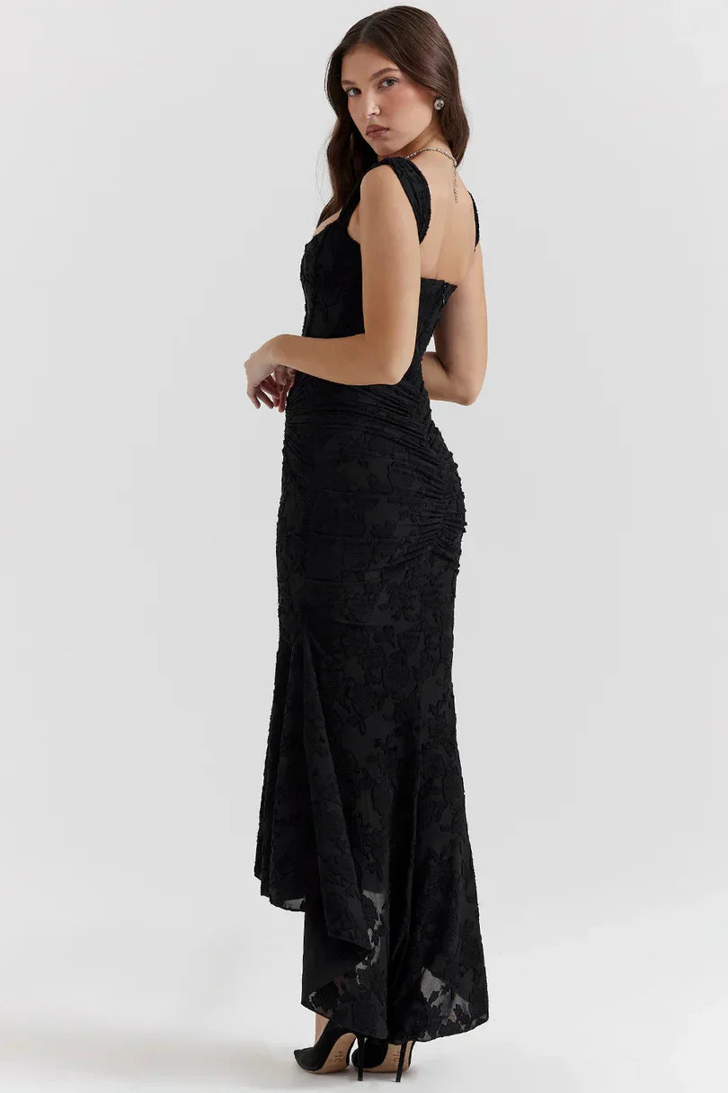 Back view of black corset dress showing open back design and lace trim