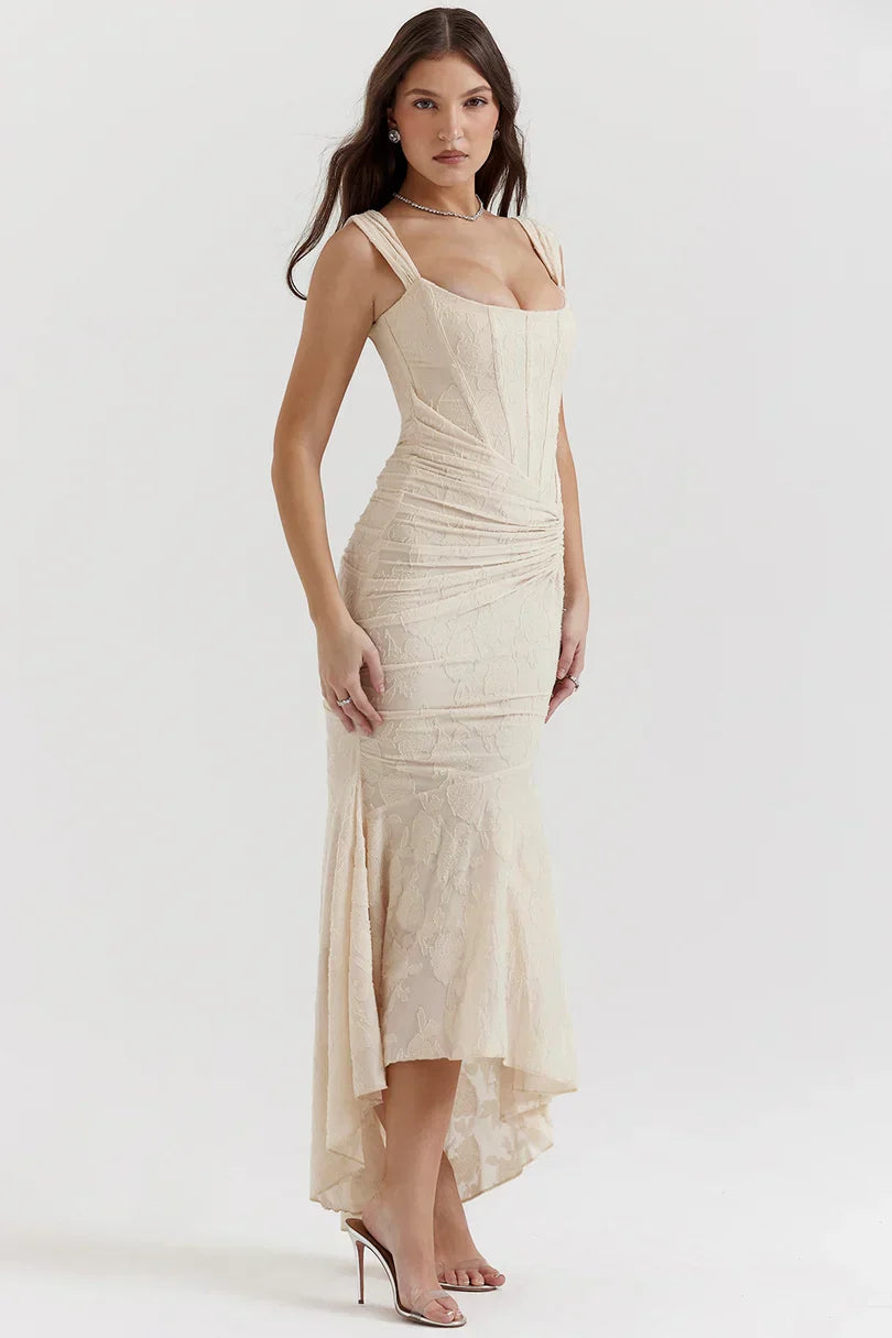 Side angle of cream corset dress showing ruched bodice and hi-lo hem