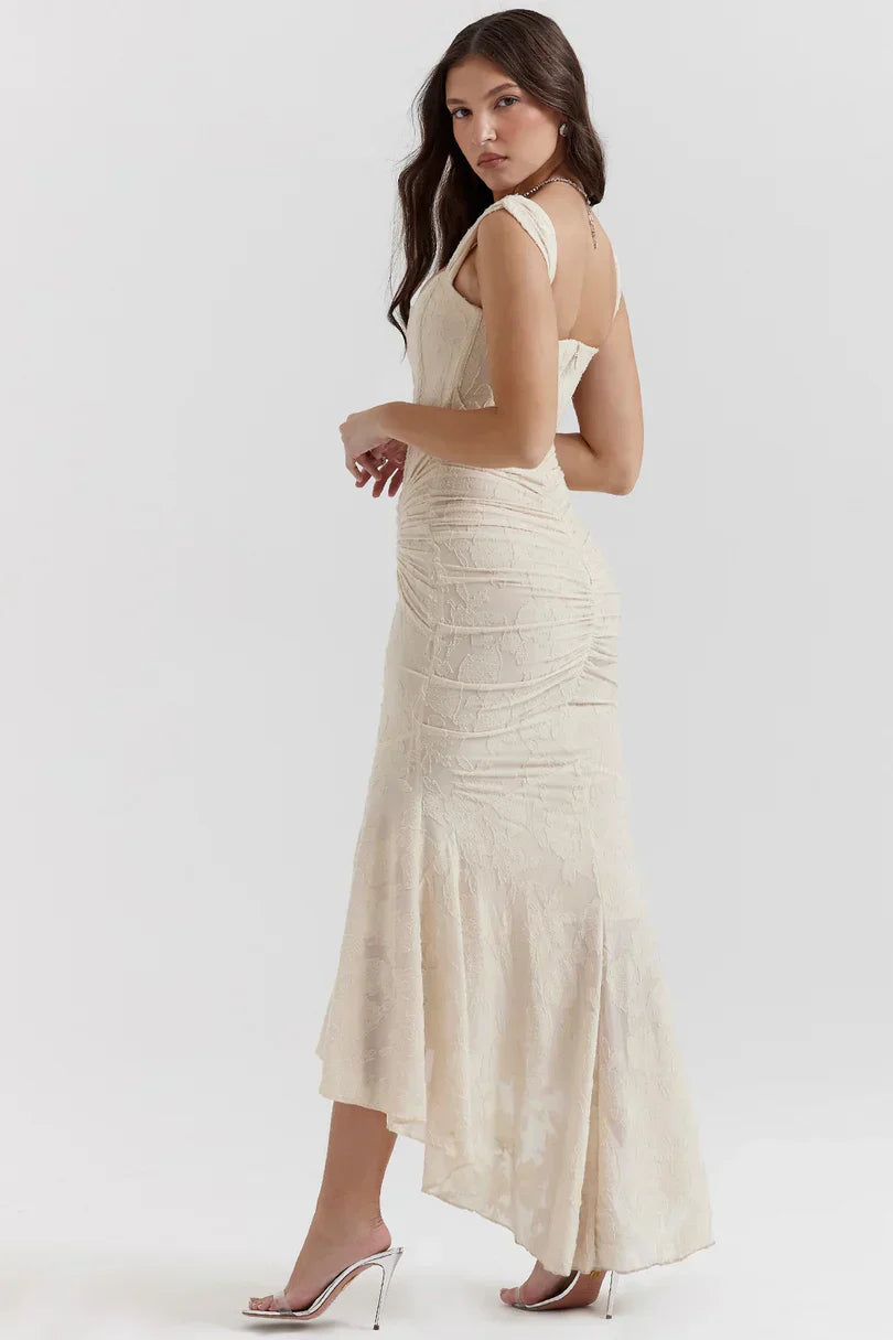 Back view of cream corset maxi dress with open back and flowing hem