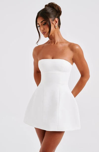 White strapless mini dress with structured A-line silhouette and side pockets