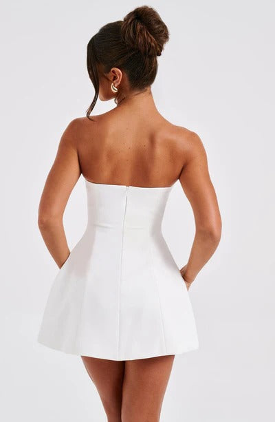 Back view of white strapless A-line dress showing center seam and bubble skirt