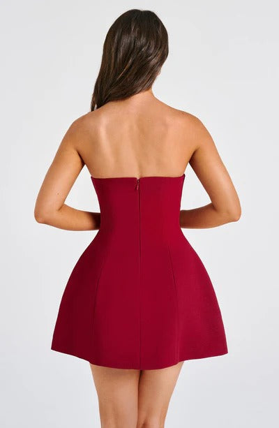 Back view of burgundy strapless A-line dress with center zip and bubble hem