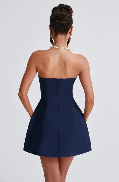 Back view of navy strapless bubble dress showing fitted waist and structured skirt