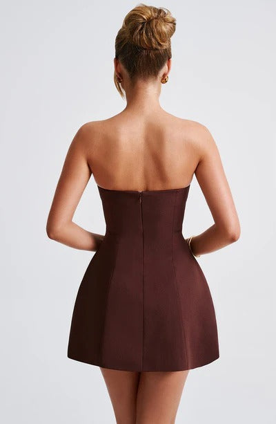Back view of burgundy strapless bubble dress showing fitted back and structured A-line shape