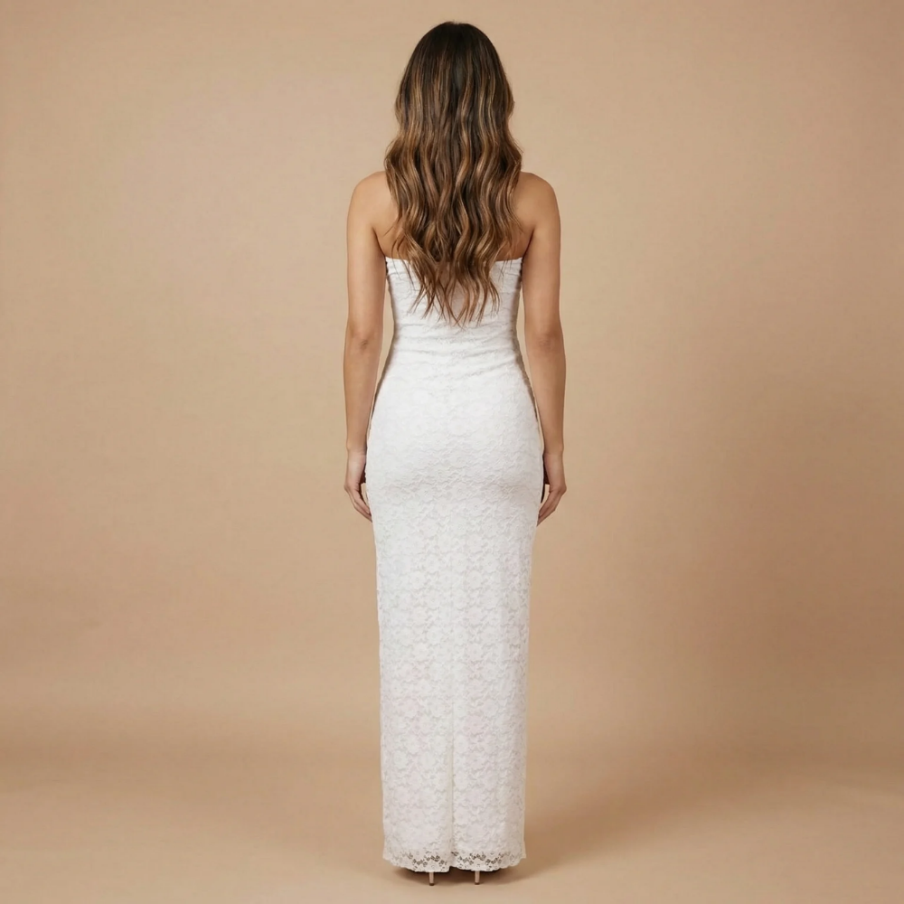 Back view of white lace strapless midi dress with ruffle slit and draped hem