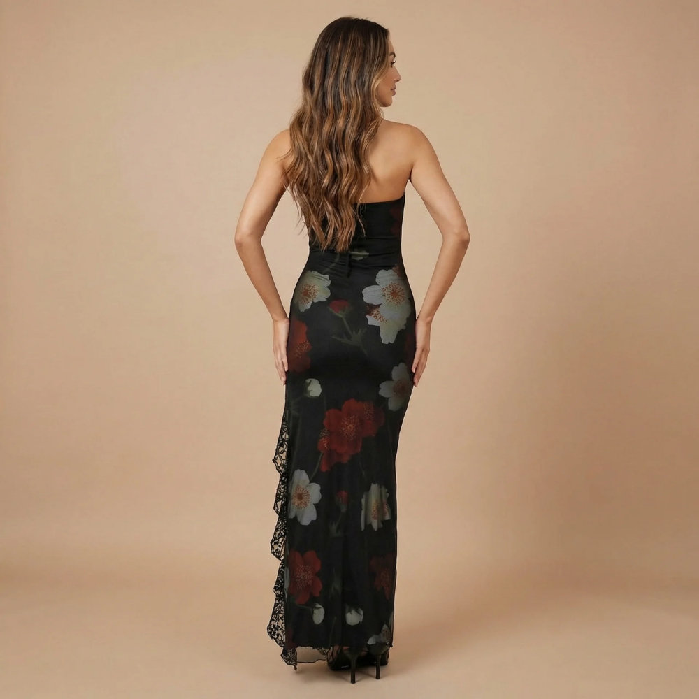 Back view of black floral midi dress with asymmetrical lace ruffle slit hem