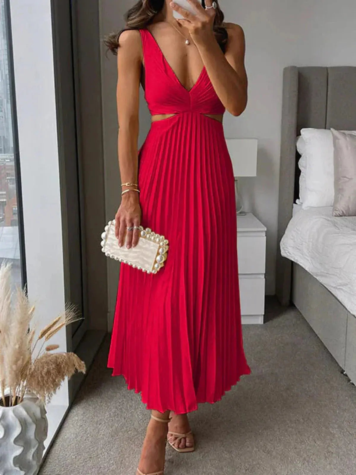 Red pleated midi dress with deep v-neck and waist cut-out detail