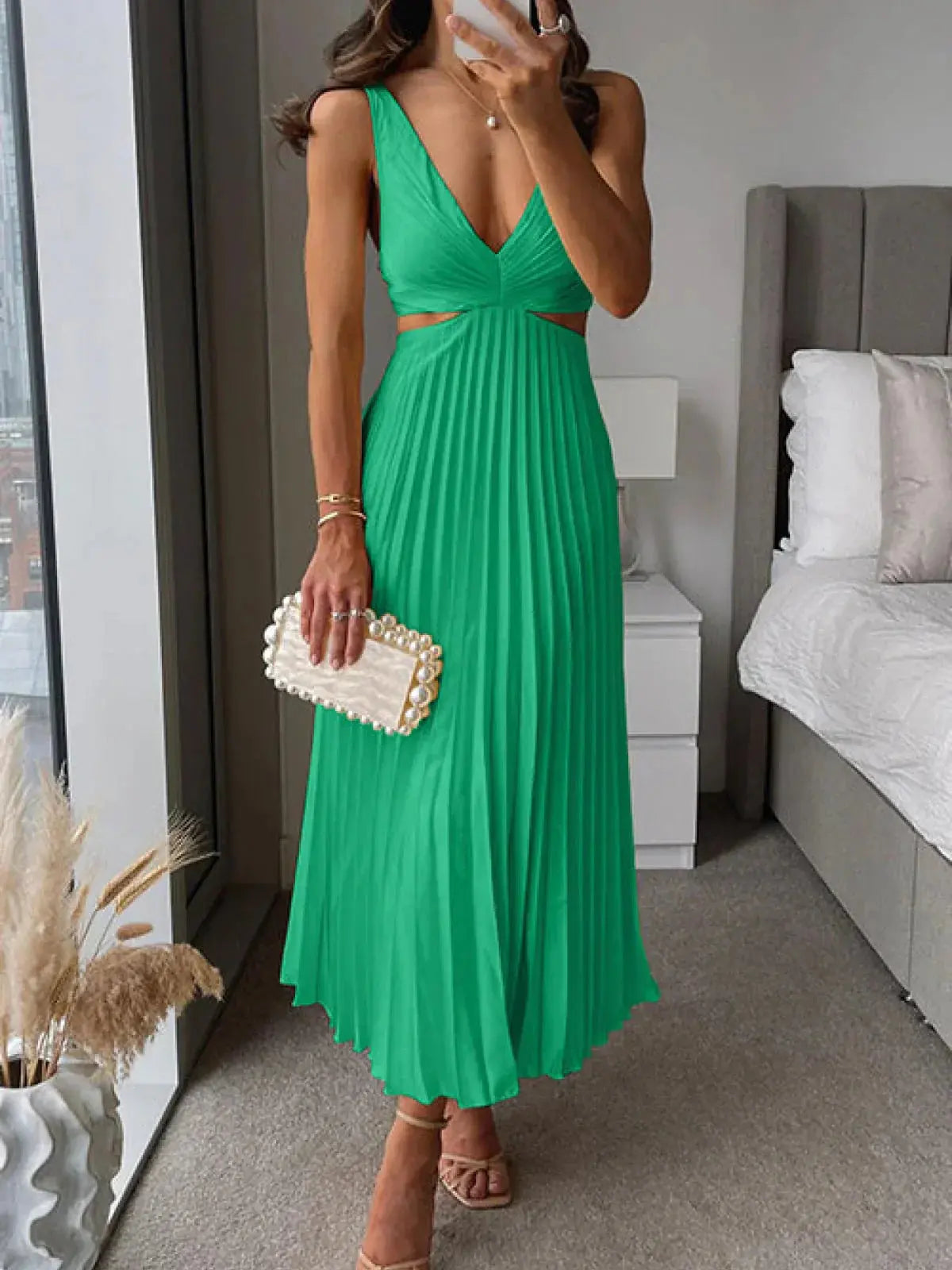 Emerald green pleated midi dress with v-neck and side cut-out