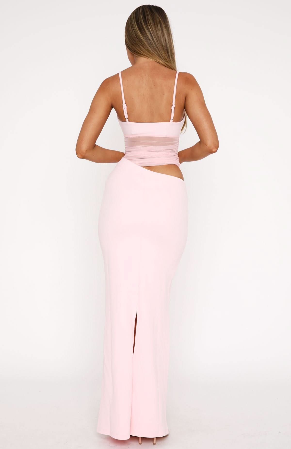 Back view of pink ruched crop maxi dress showing open back and slit hem