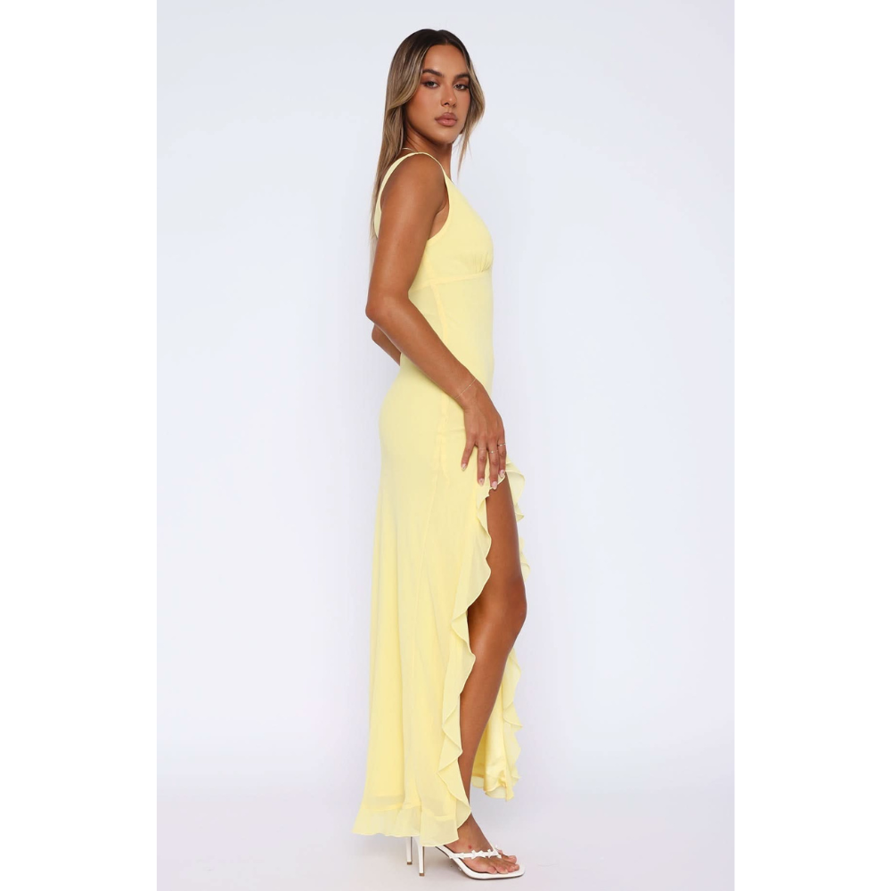 Side view of yellow maxi dress showing ruffled asymmetrical skirt