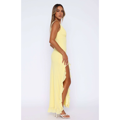 Side view of yellow maxi dress showing ruffled asymmetrical skirt