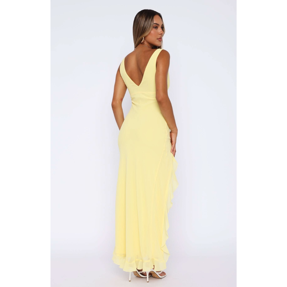 Back view of yellow v-neck maxi dress with flowing ruffled hem