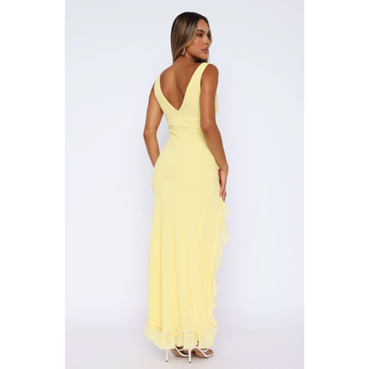 Back view of yellow v-neck maxi dress with flowing ruffled hem