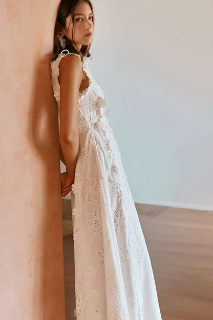 Back view of white eyelet maxi dress showing lace-up corset closure