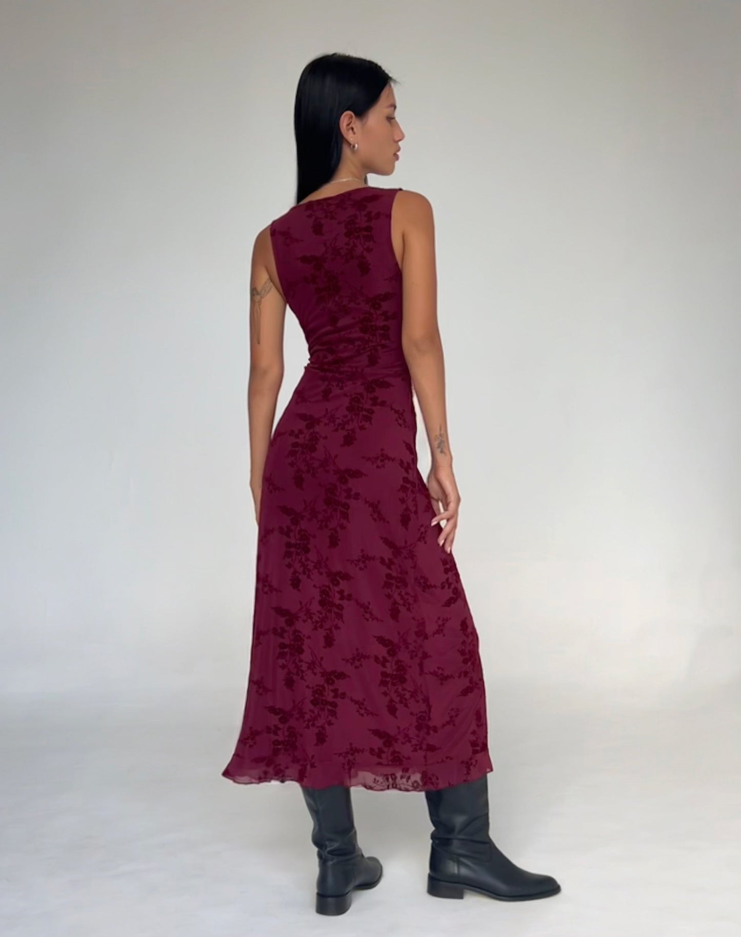 Back view of burgundy floral midi dress showing sleeveless design and hem