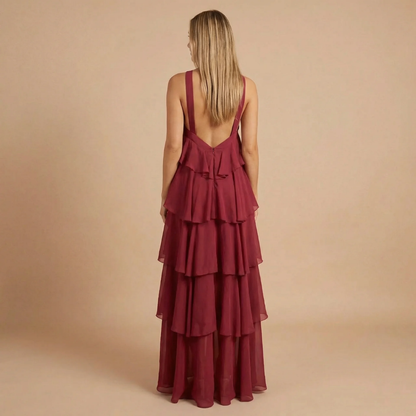 Back view of burgundy halter maxi dress displaying open back and stacked tiered design