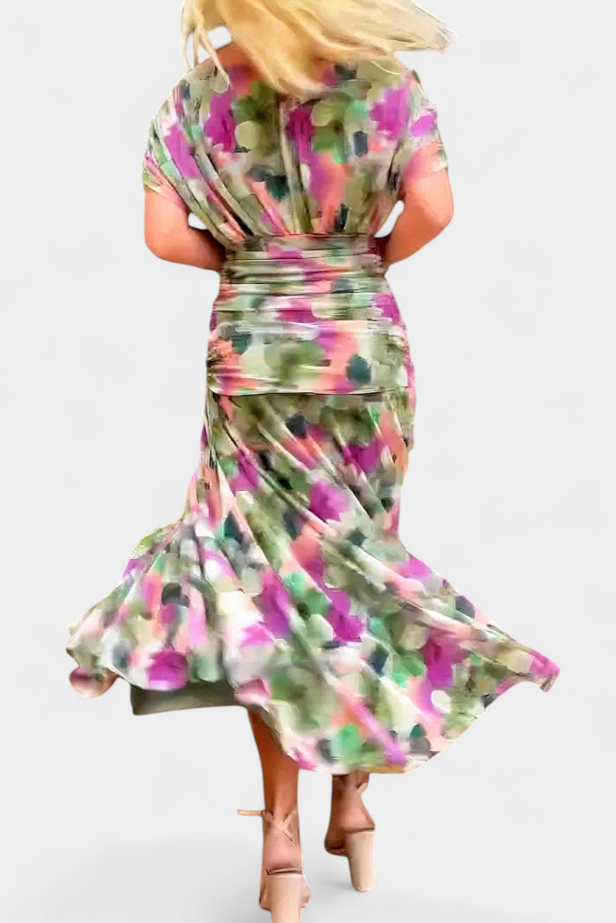 Rear angle of floral off-shoulder dress showing ruched details and flowing fabric