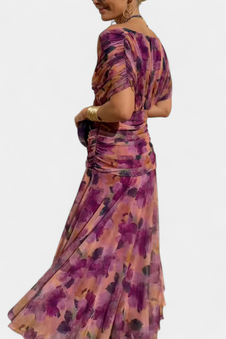 Back view of purple floral ruched midi dress showing gathered waist detail