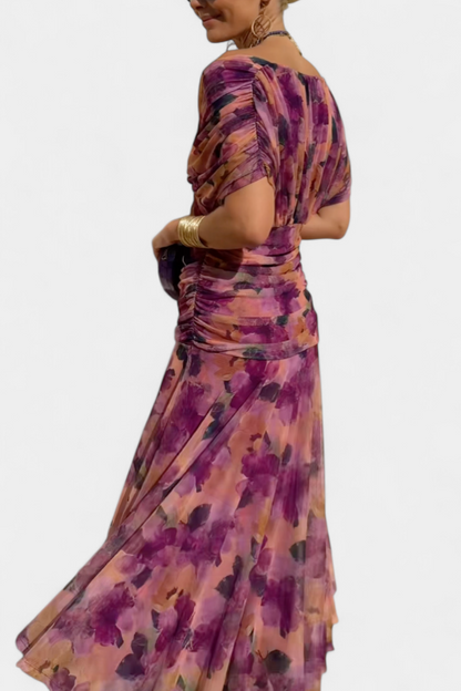 Back view of purple floral ruched midi dress showing gathered waist detail