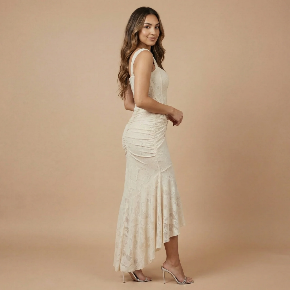 Side view of cream ruched jacquard dress showing asymmetrical high-low silhouette