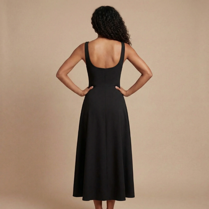 Back view of black midi dress with open back and pleated hem