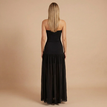 Back view of black strapless maxi dress with layered hem