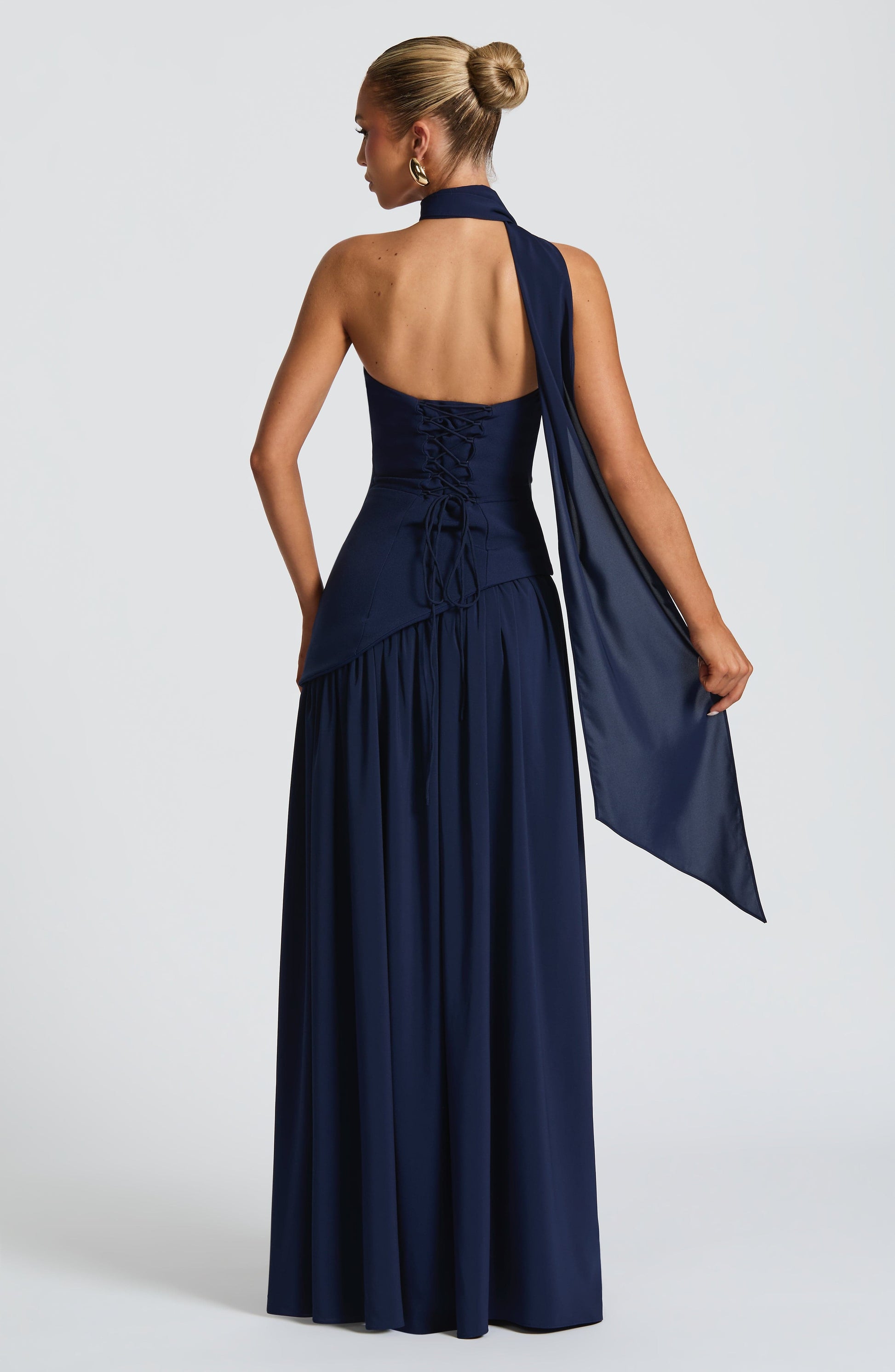 Navy halter strapless maxi dress with ruched bodice and flowing slit back view