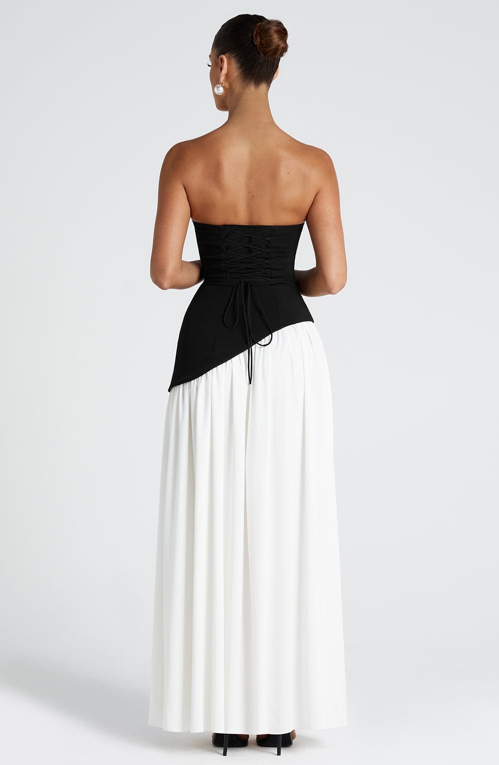 Black and ivory colorblock strapless maxi dress with asymmetrical hem and slit