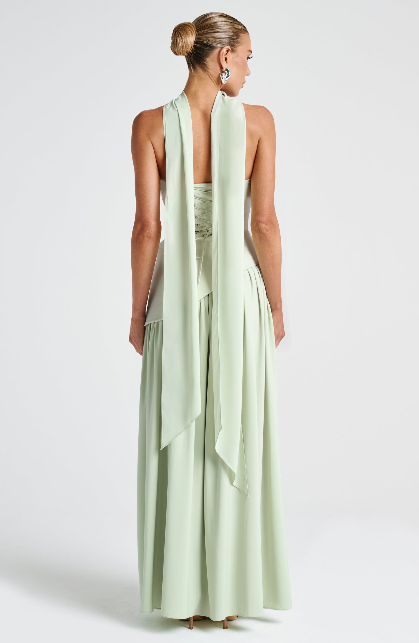 Sage green strapless maxi dress back view with flowing skirt and slit